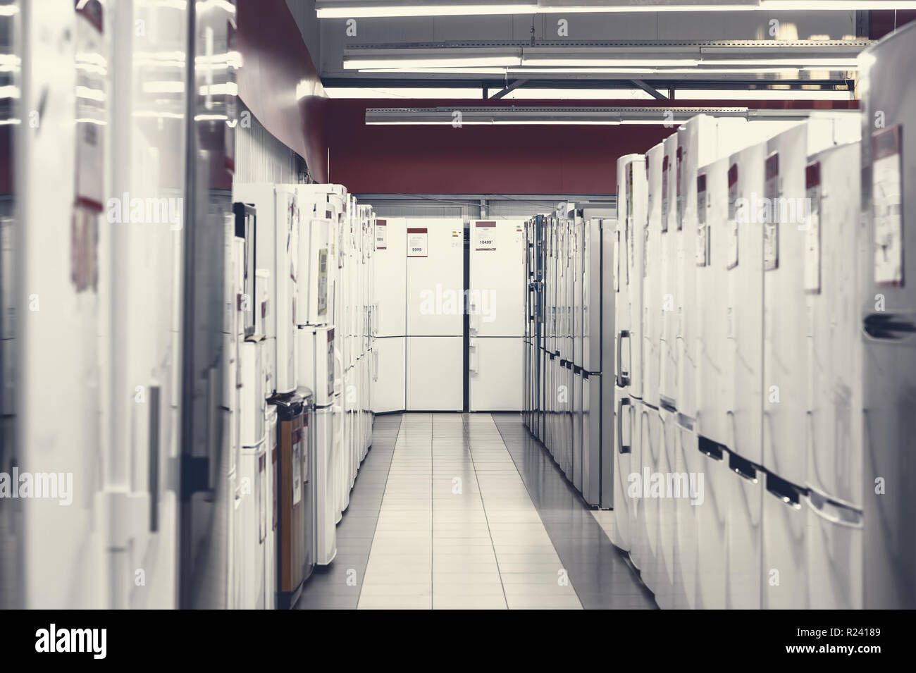 rows of refrigerators in appliance store Stock Photo