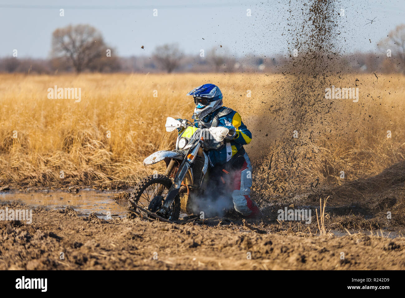 Enduro bike rider stuck in the deep mud Stock Photo