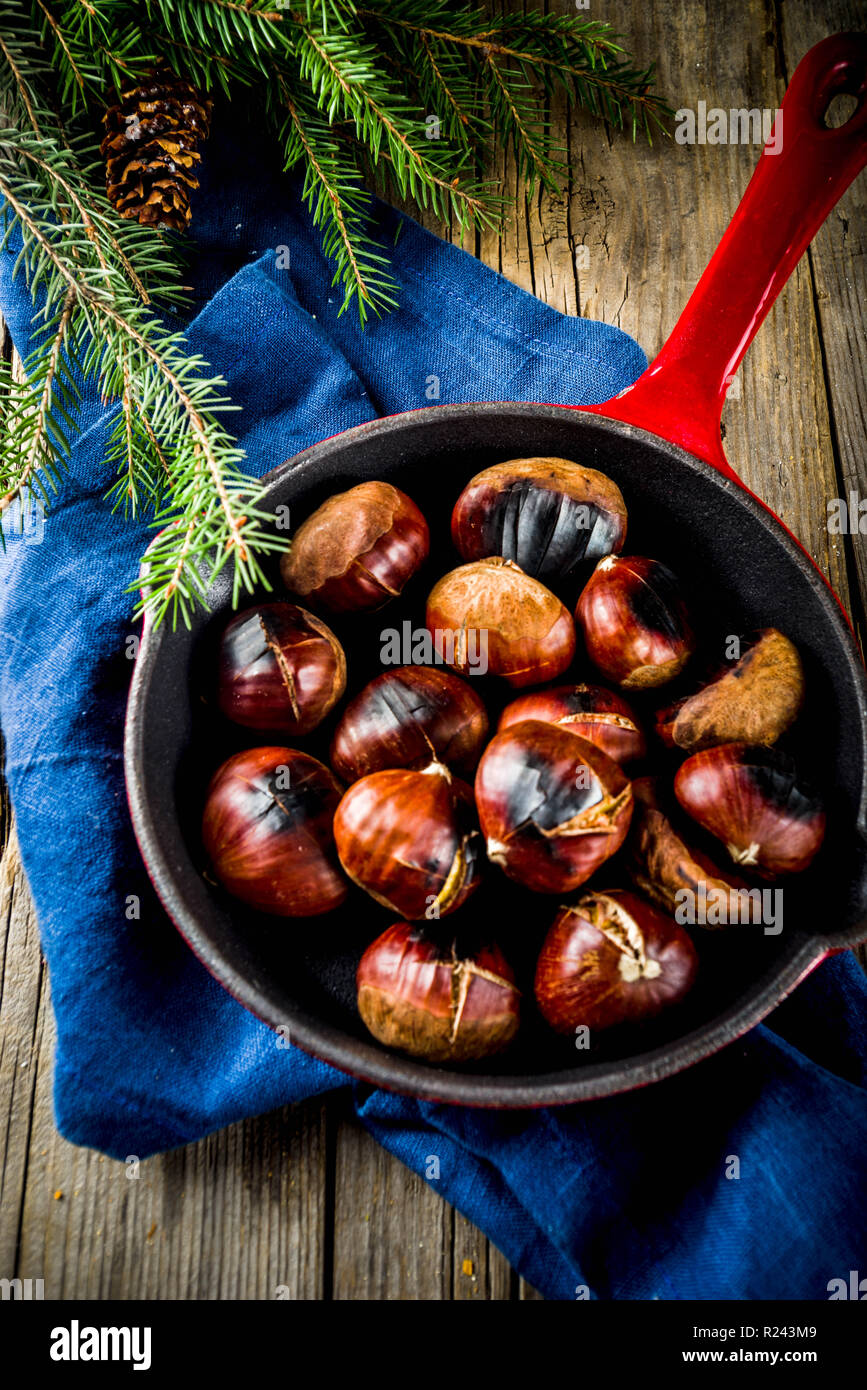 Cracked roasted chestnuts, traditional autumn winter homemade snack, on