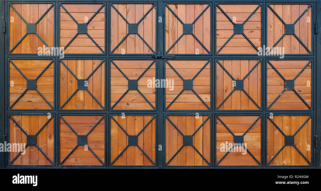 wooden gate with wrought iron as background Stock Photo - Alamy