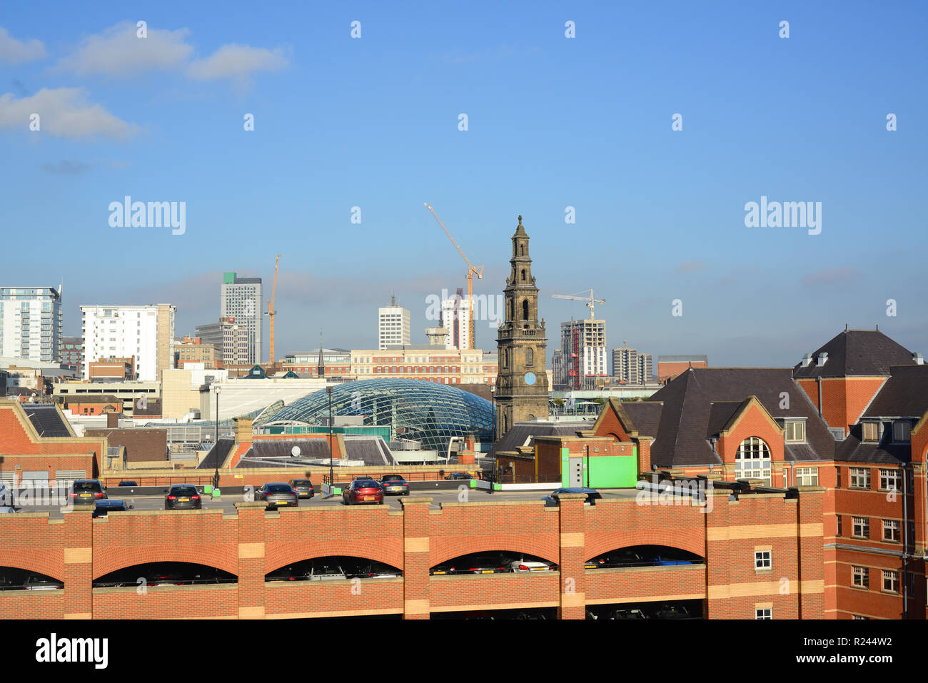 trinity shopping complex designed by chapman taylor leeds by trinity church built in 1722 yorkshire united kingdom Stock Photo