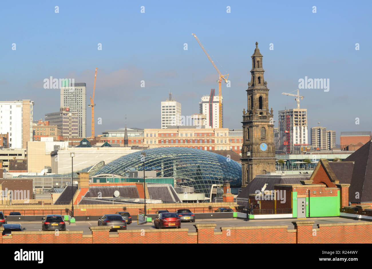 trinity shopping complex designed by chapman taylor leeds by trinity church built in 1722 yorkshire united kingdom Stock Photo