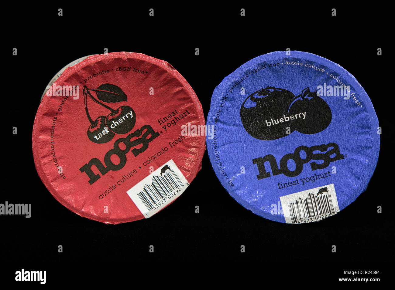 New York, November 12, 2018: Two tubs of Noosa yogurt on black background. Stock Photo