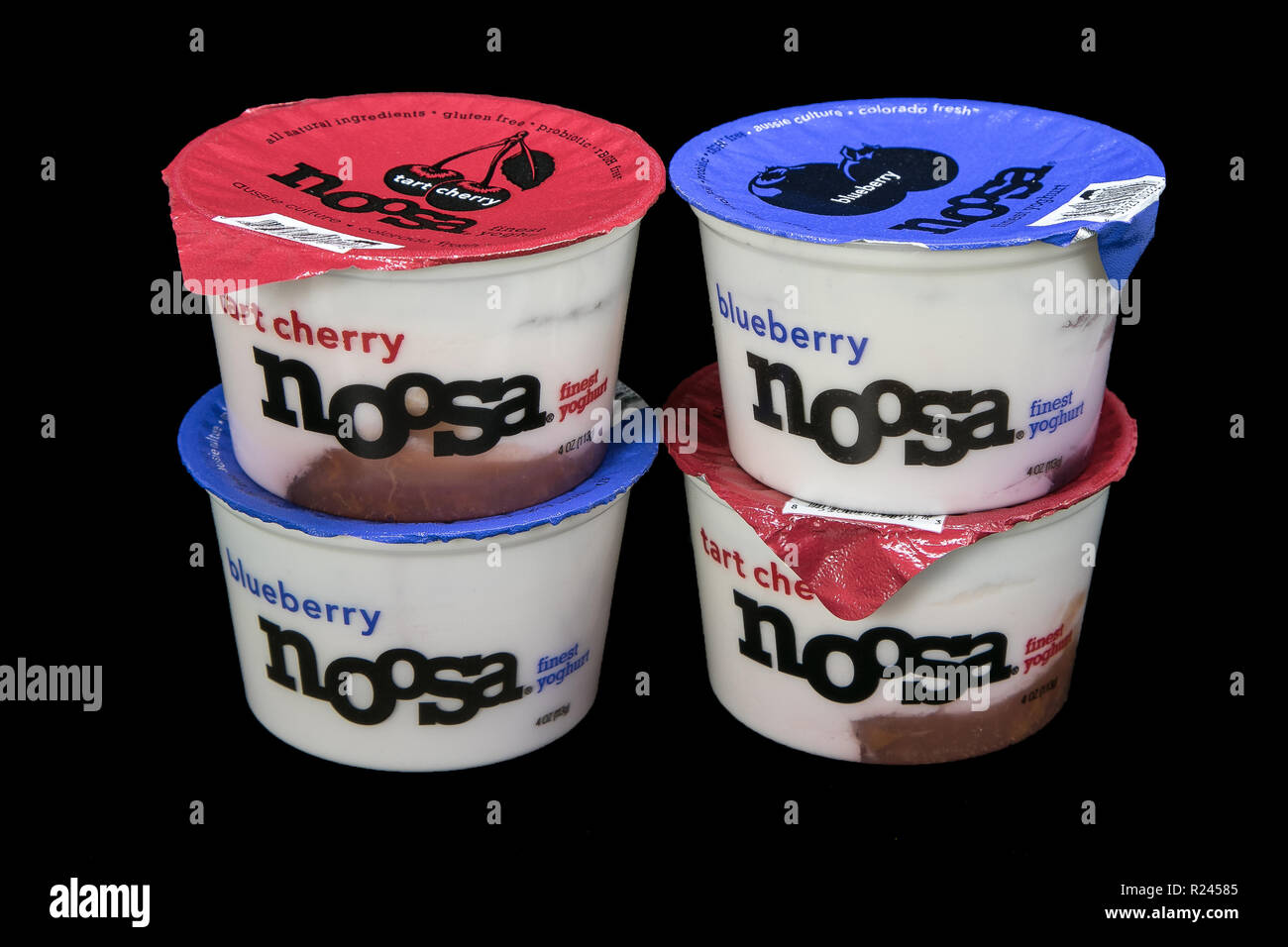 New York, November 12, 2018: Four tubs of Noosa yogurt on black background. Stock Photo