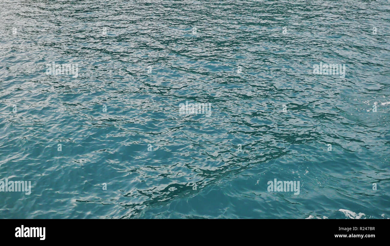 Foam wave of the sea surface from the movement of the ferry. View of the Busanga Mountains.The city of Coron. The Palawan Islands of the Philippines. Stock Photo