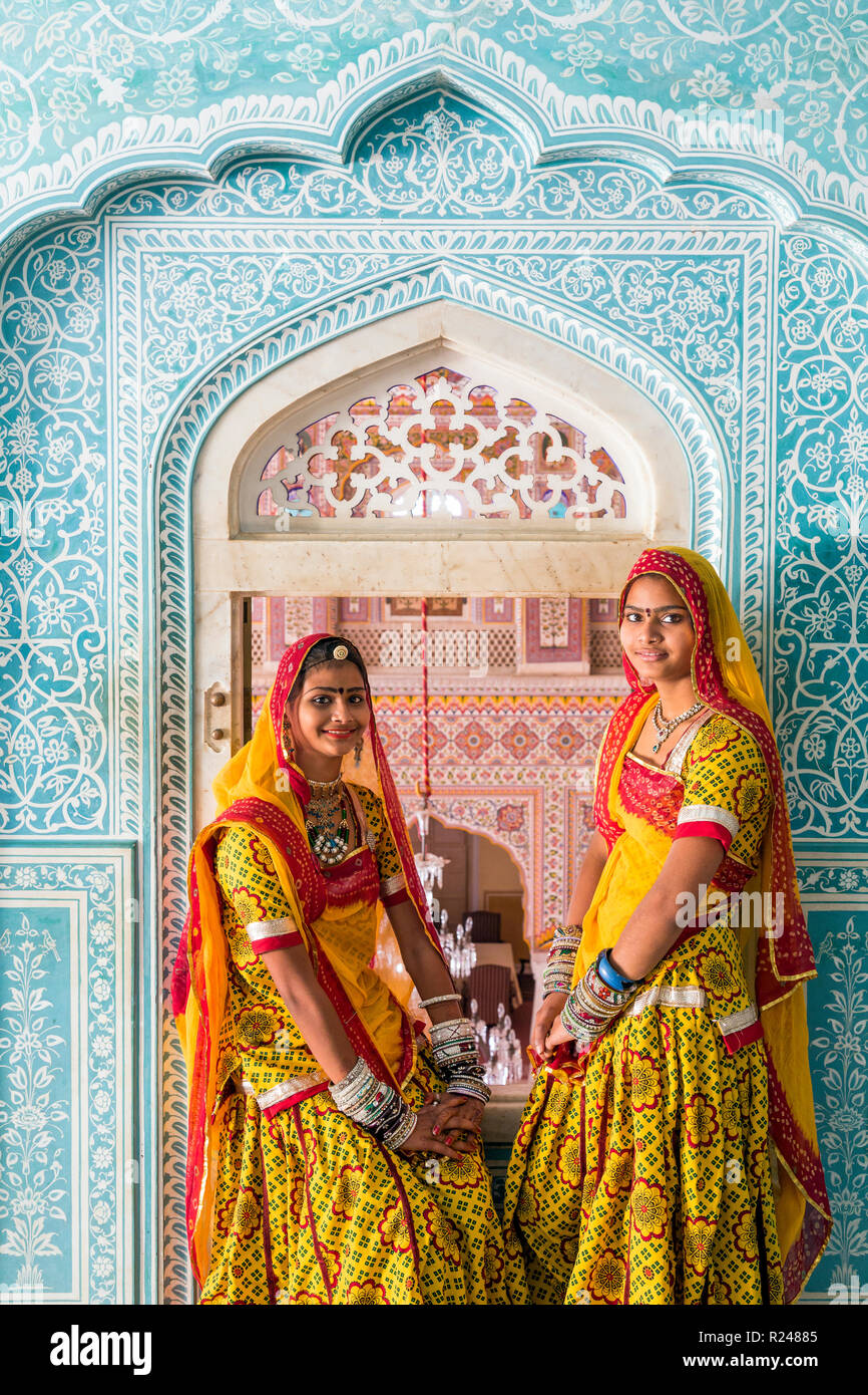 Ladies wearing colourful saris in ornate passageway, Samode Palace, Jaipur, Rajasthan, India, Asia Stock Photo