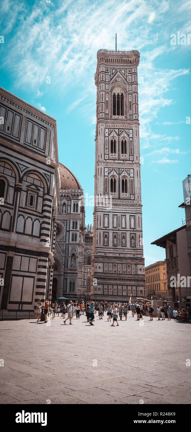 Vertical photo with famous tower Campanile di Giotto. Tower is colorful with many sculptures and bells on top. Tower is in town Florence in Italy Tusc Stock Photo