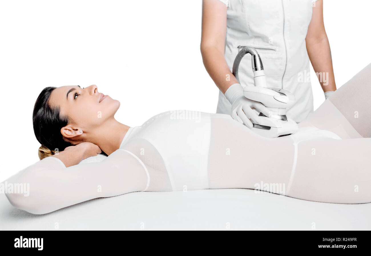 Beautiful woman getting beauty therapy against cellulite with LPG machine on her belly. LPG massage for lifting body and belly Stock Photo