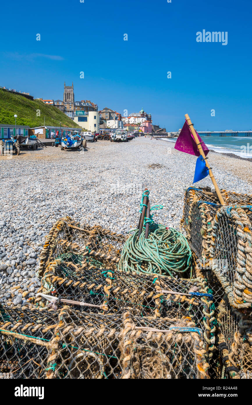 View of fishing baskets on the beach and Parish Church overlooking pier on a summer day, Cromer, Norfolk, England, United Kingdom, Europe Stock Photo
