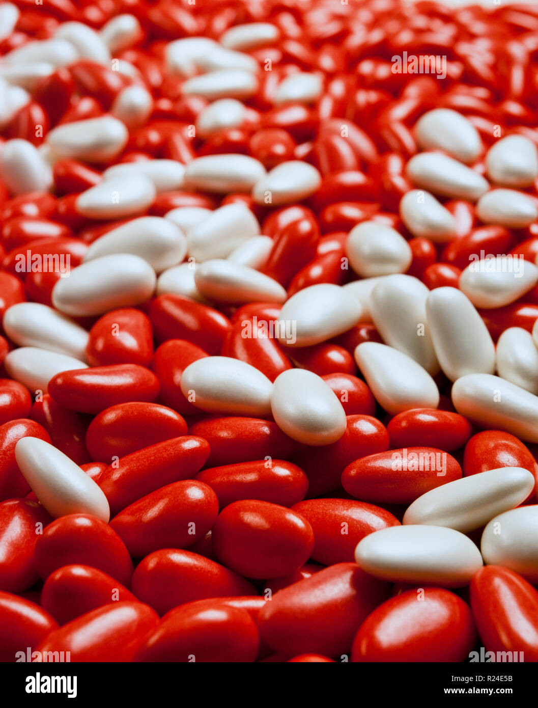 Large group of red and white candycoated almonds still life Stock