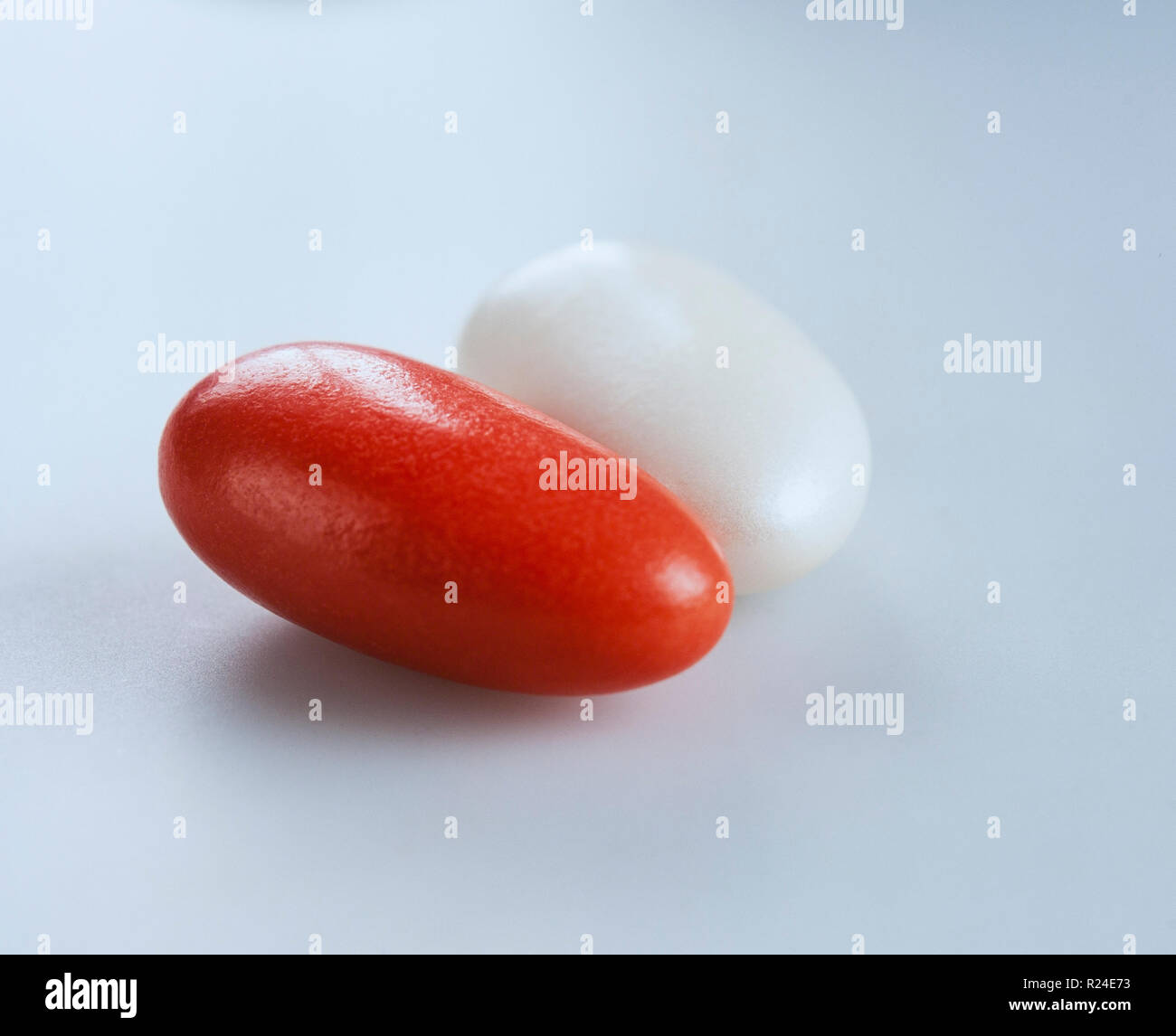 A couple of red and white candy-coated almonds Stock Photo