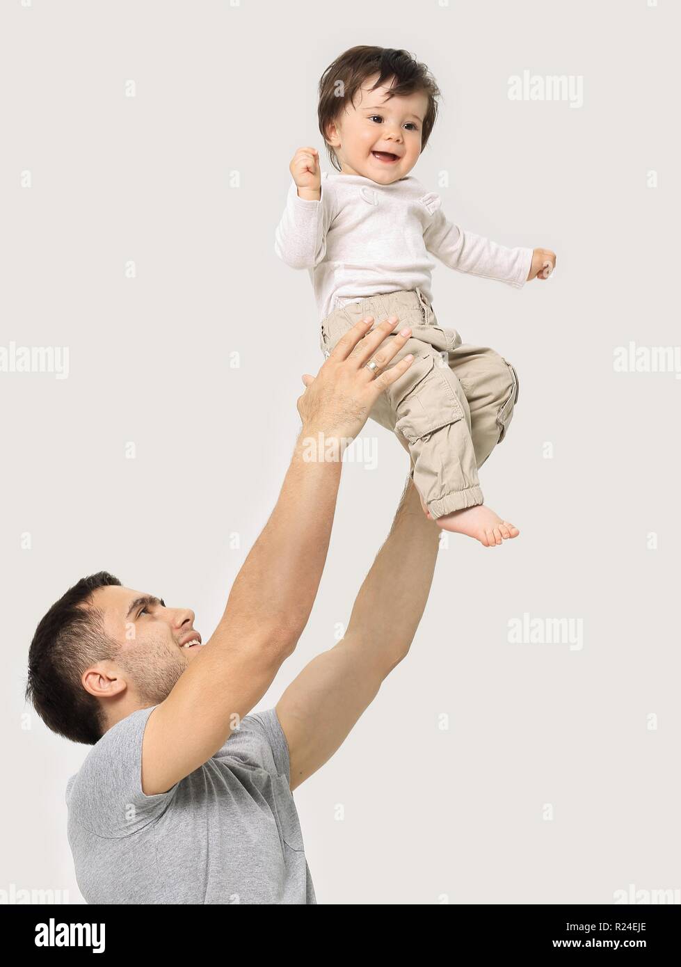 Father tossing baby in the air Stock Photo Alamy