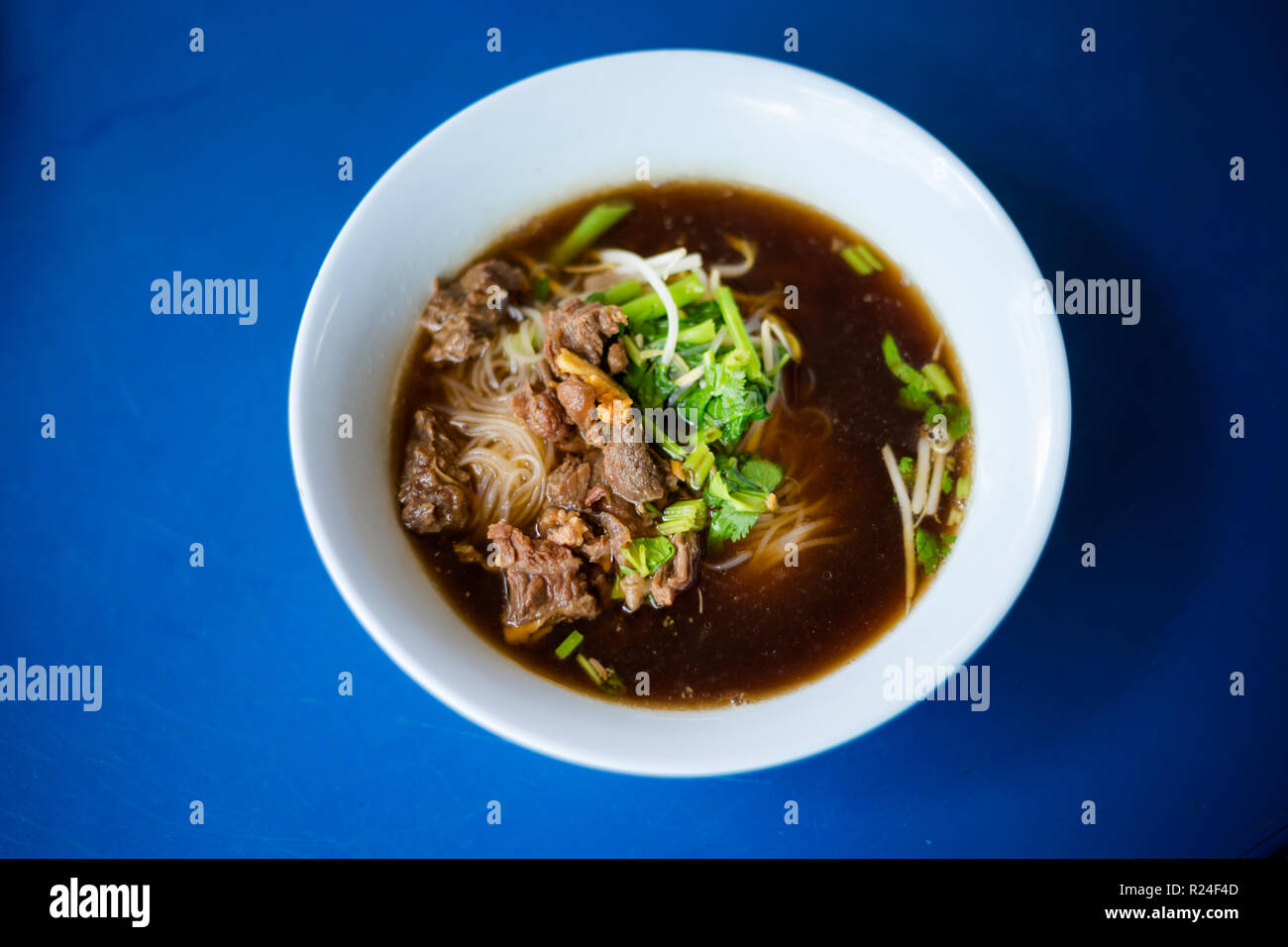 Fresh prepared asian aromatic dark soy sauce broth steamed meat soup
