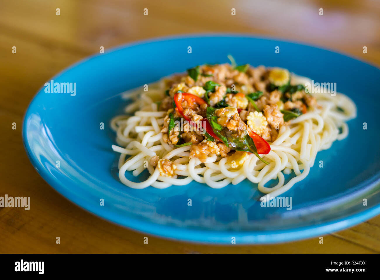 Fresh prepared asian spicy minced meat spaghetti served in local restaurant on Koh Mook island. Traditional thai cuisine made of fresh ingredients. Stock Photo