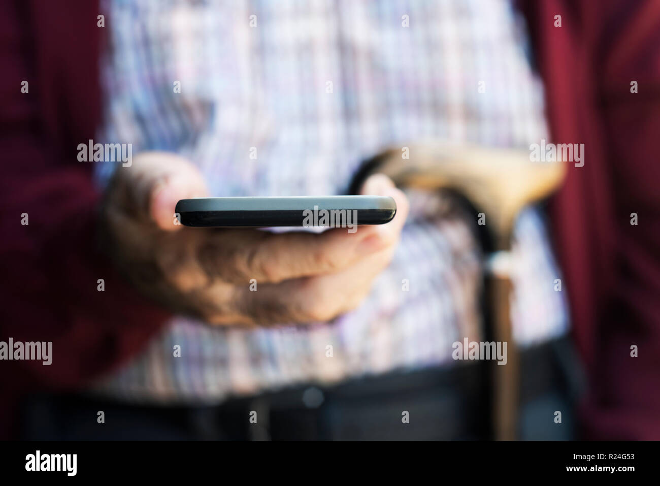 Old man walking phone hi-res stock photography and images - Alamy