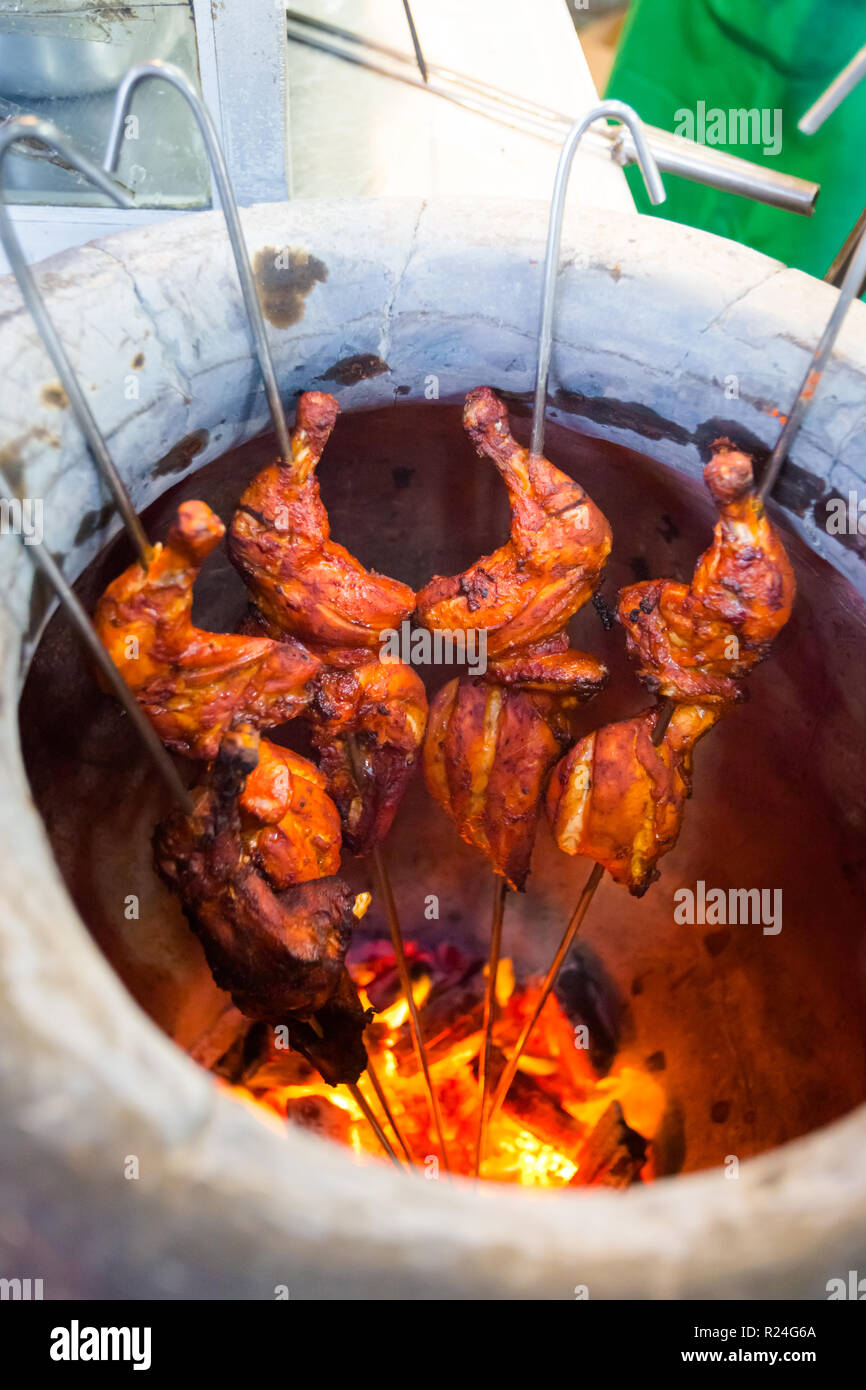 Fresh prepared malaysian tandoori chicken pieces in indian oven in local restaurant in Cameron
