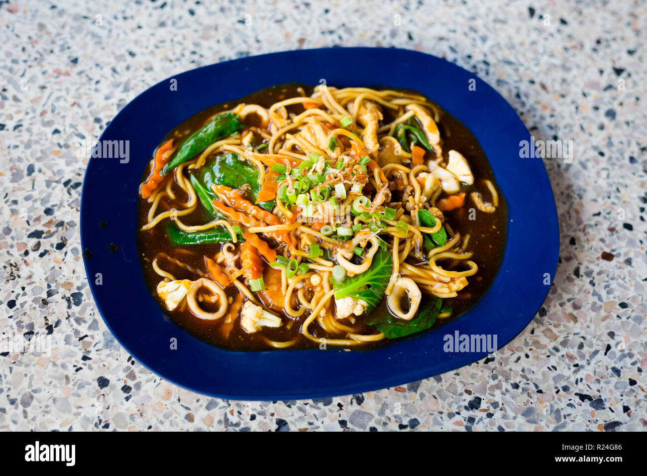 Fresh prepared malaysian fried hailam seafood noodles served in local