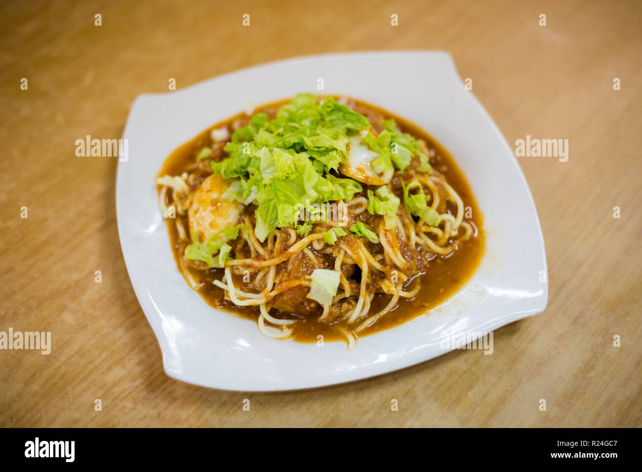 Fresh prepared malaysian Mee Rojak fried noodles with vegetables in ...