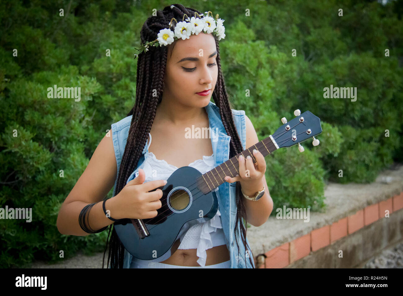 Front View Of A Young Beautiful Girl With Braided Hair Playing