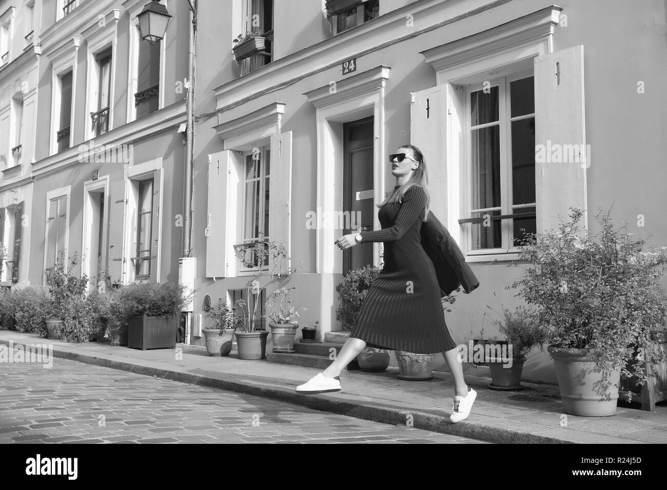 Step by step. Guide to spare time in French capital. Woman total red