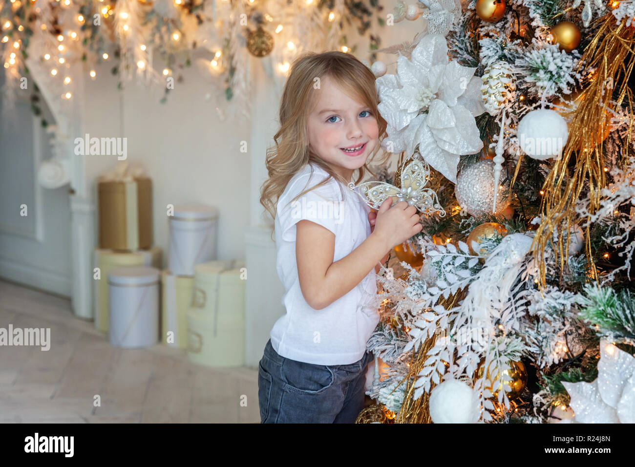 Little Girl Decorating Christmas Tree On Christmas Eve At