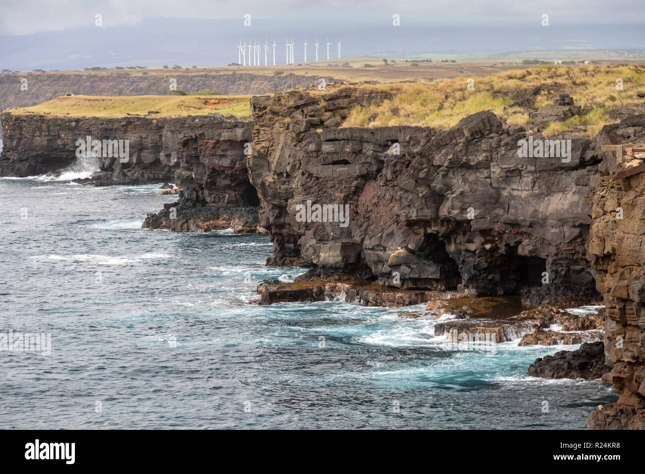 Ka Lae, Hawaii - The Pakini Nui Wind Farm above Pacific Ocean cliffs at South Point on Hawaii's Big Island. The wind is almost constantly blowing at S Stock Photo
