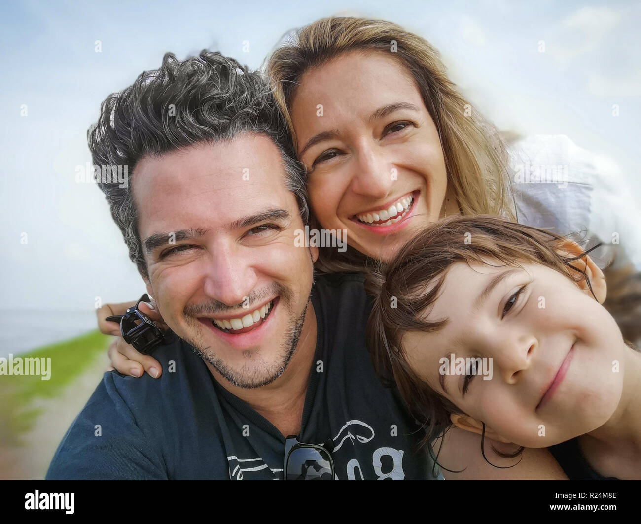caucasian family portrait selfie only son thirty year old parents only son child . Stock Photo