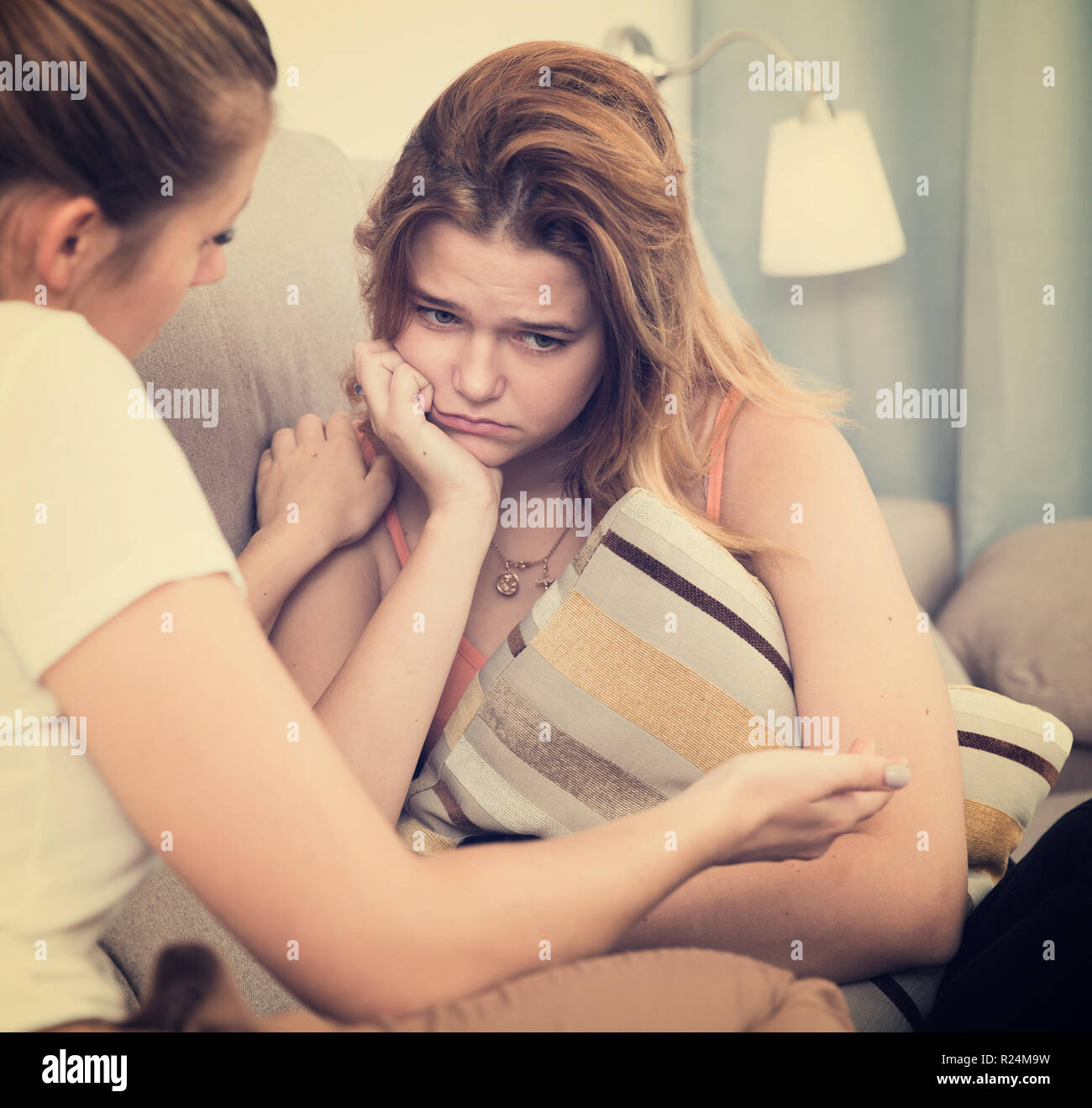 Young girl is comforting her sad girlfriend at her home Stock Photo - Alamy