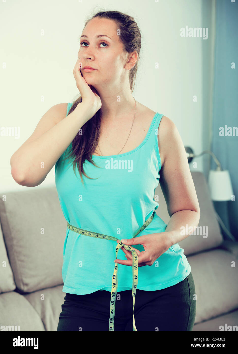 Young woman having problems with weight gain at home Stock Photo Alamy