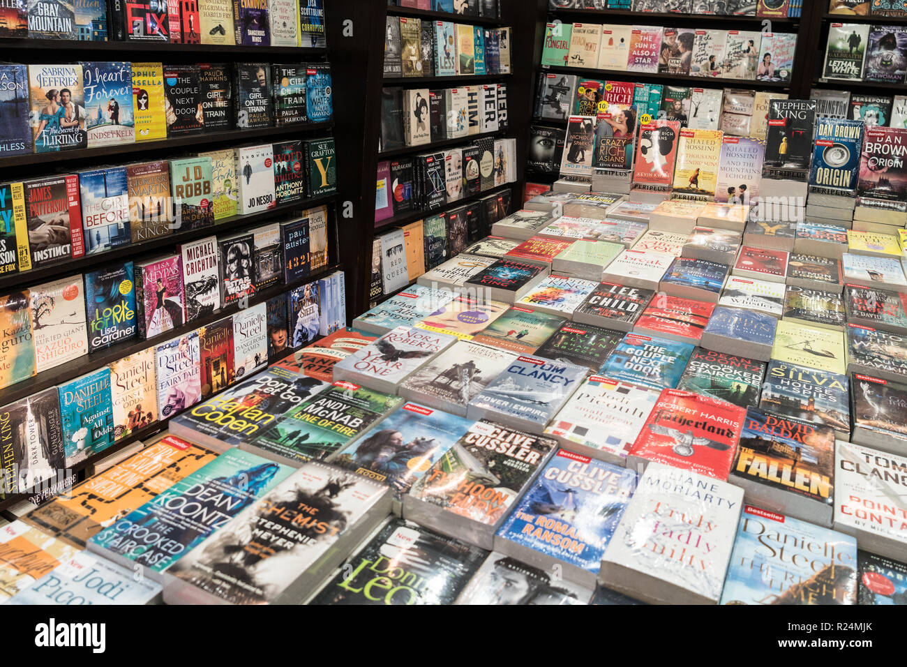 Jakarta, Indonesia - November 13 2018: Various paperback novels displayed in a modern bookstore. Stock Photo