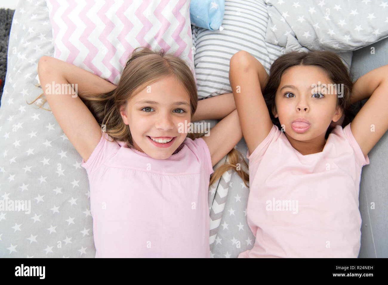 Best friends forever. Girls children lay on bed with cute pillows ...