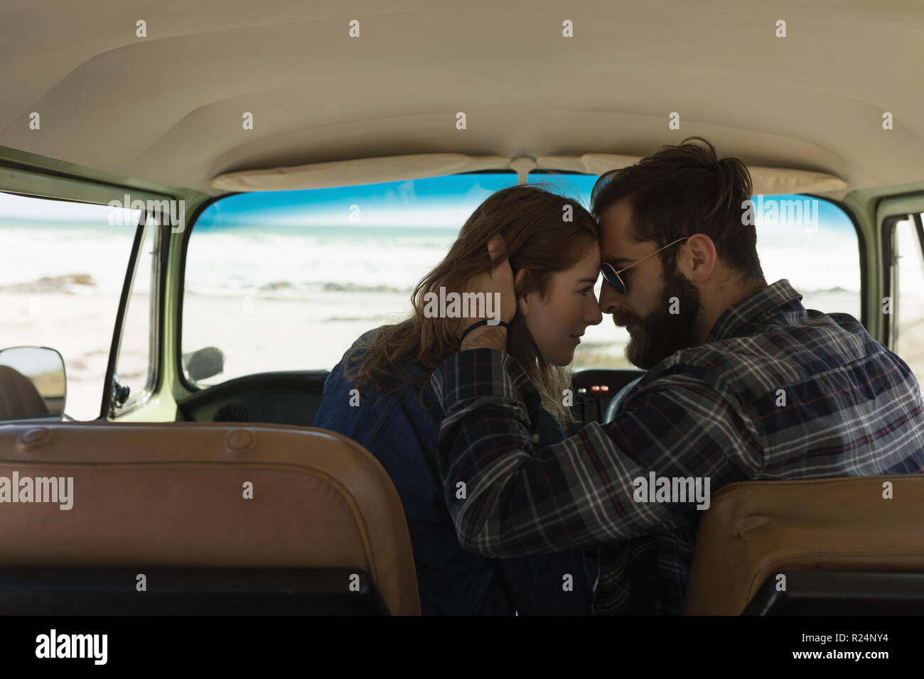 Couple embracing in vehicle on roadtrip Stock Photo