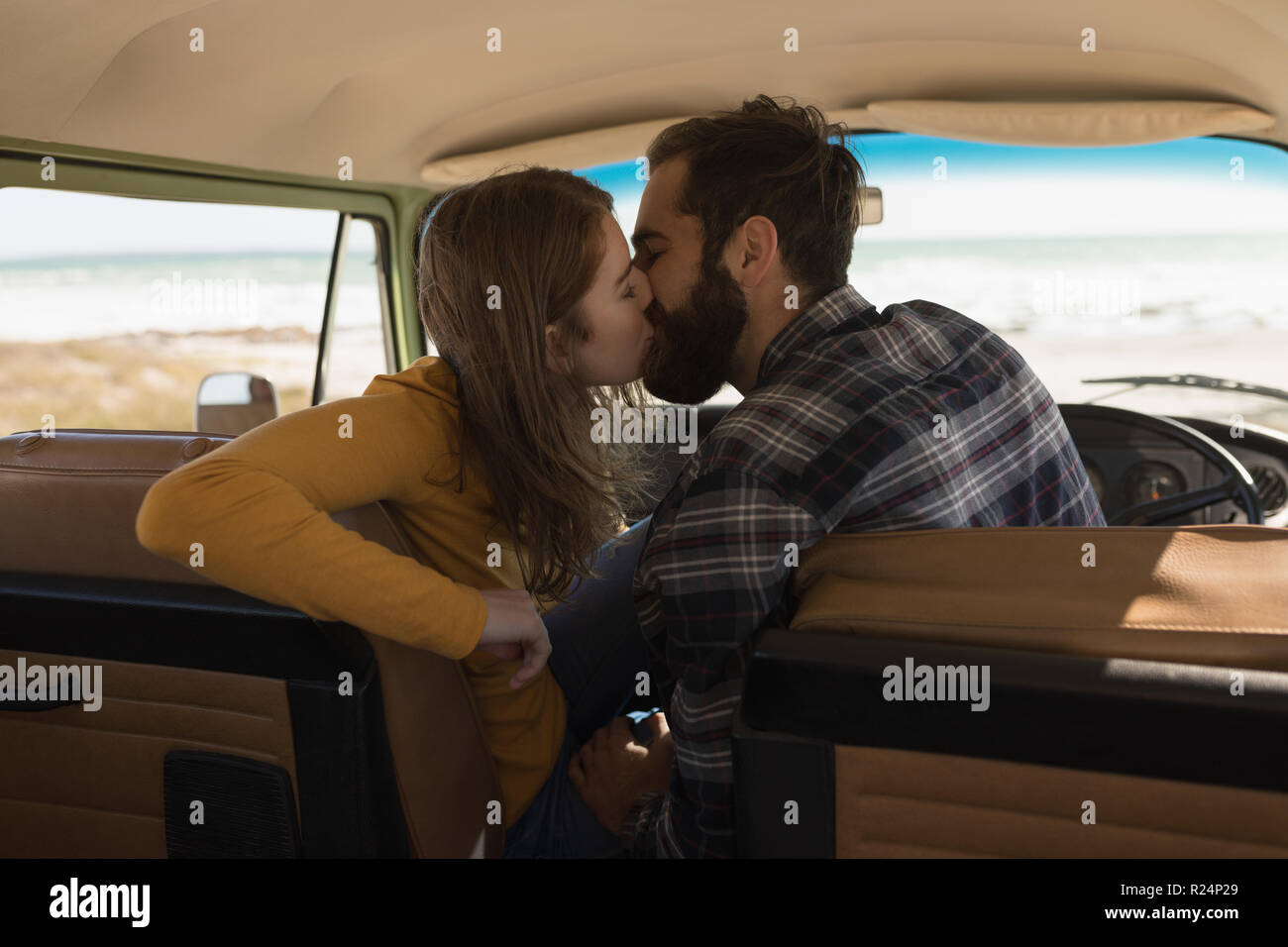 Couple kissing in vehicle on roadtrip Stock Photo