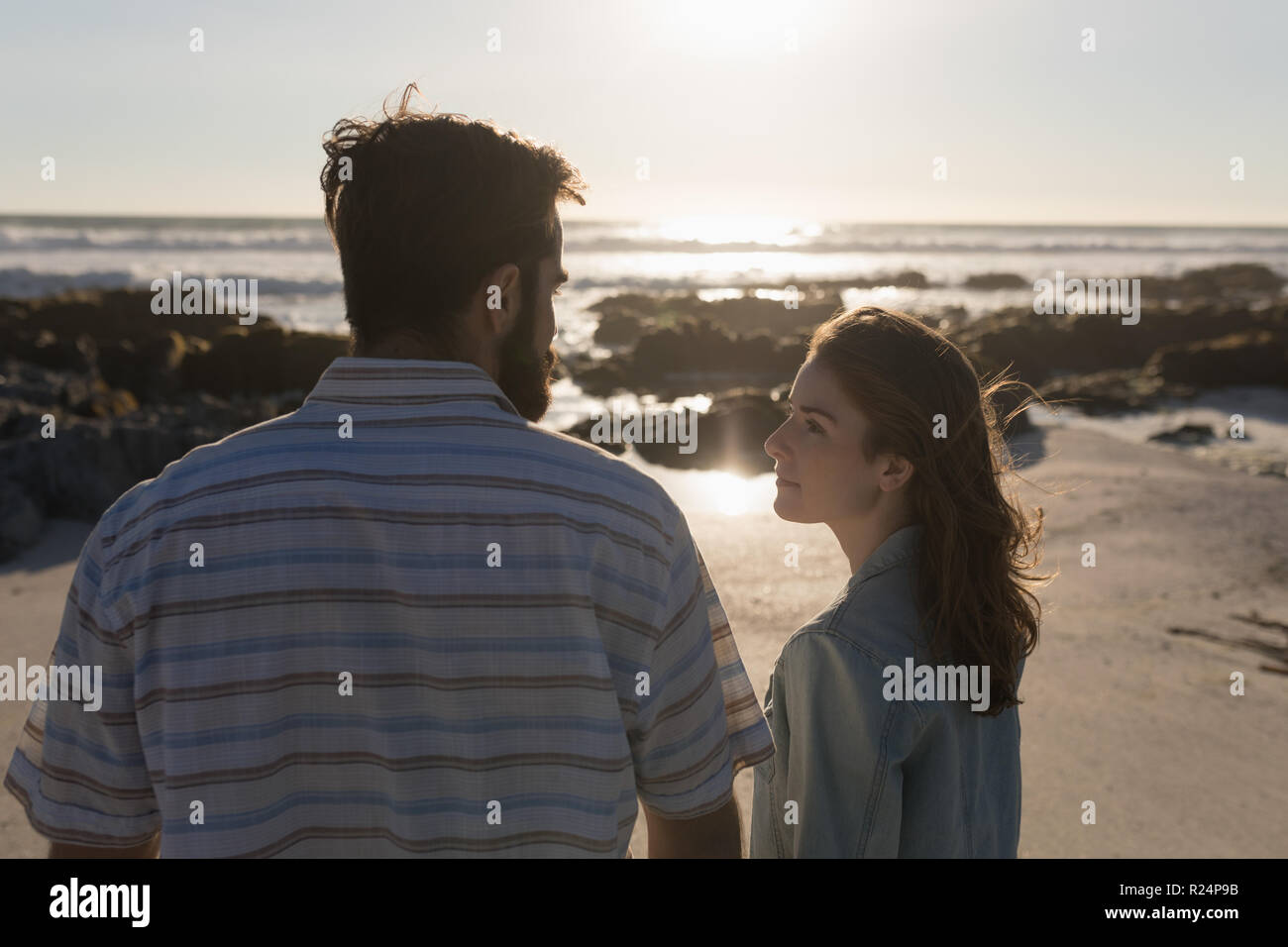 Man woman beach looking at each other hi-res stock photography and ...