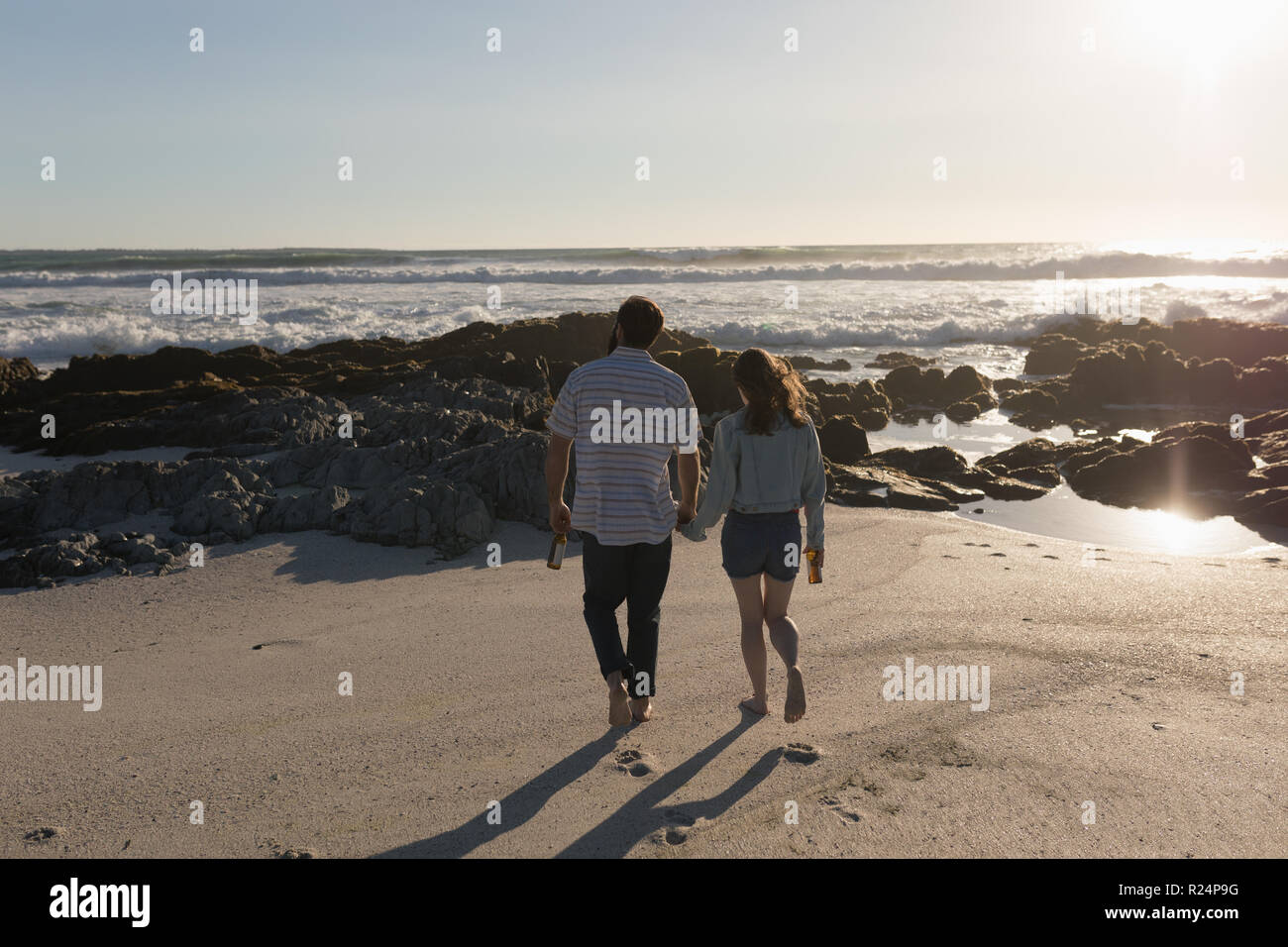 Couple holding hands walking summer hi-res stock photography and images ...