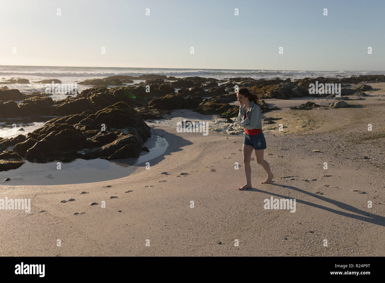 Attractive man walking on beach hi-res stock photography and images - Alamy