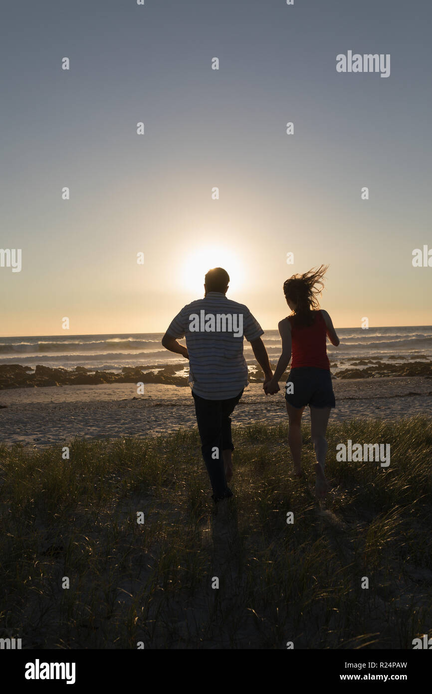 Man woman holding hands running hi-res stock photography and images - Alamy
