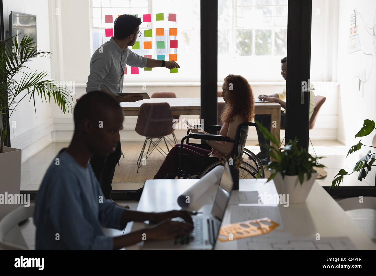 Executives discussing on sticky notes Stock Photo