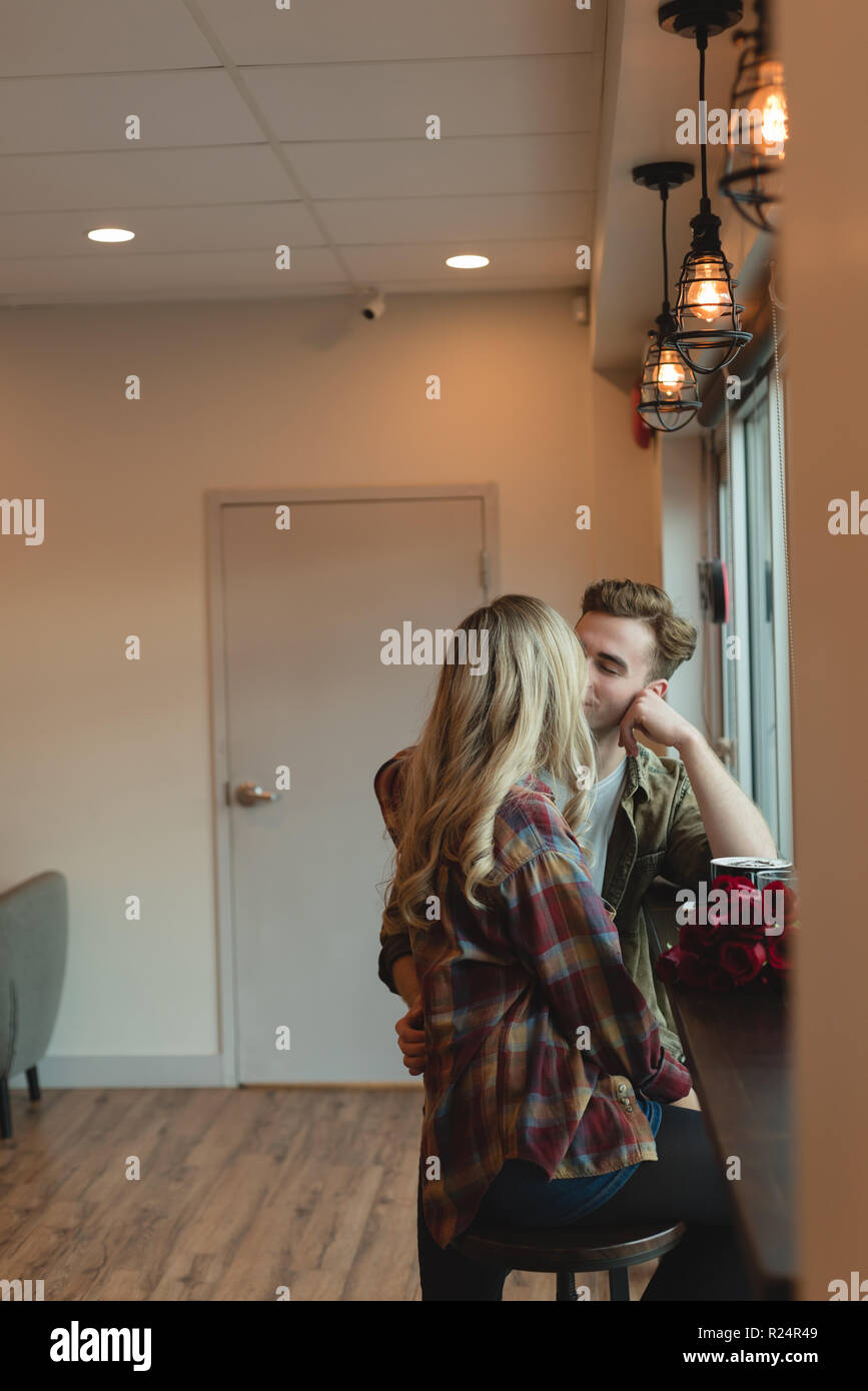 Couple kissing each other in cafe Stock Photo