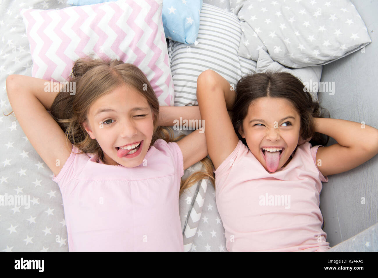 Slumber party timeless childhood tradition. Girls relaxing on bed ...