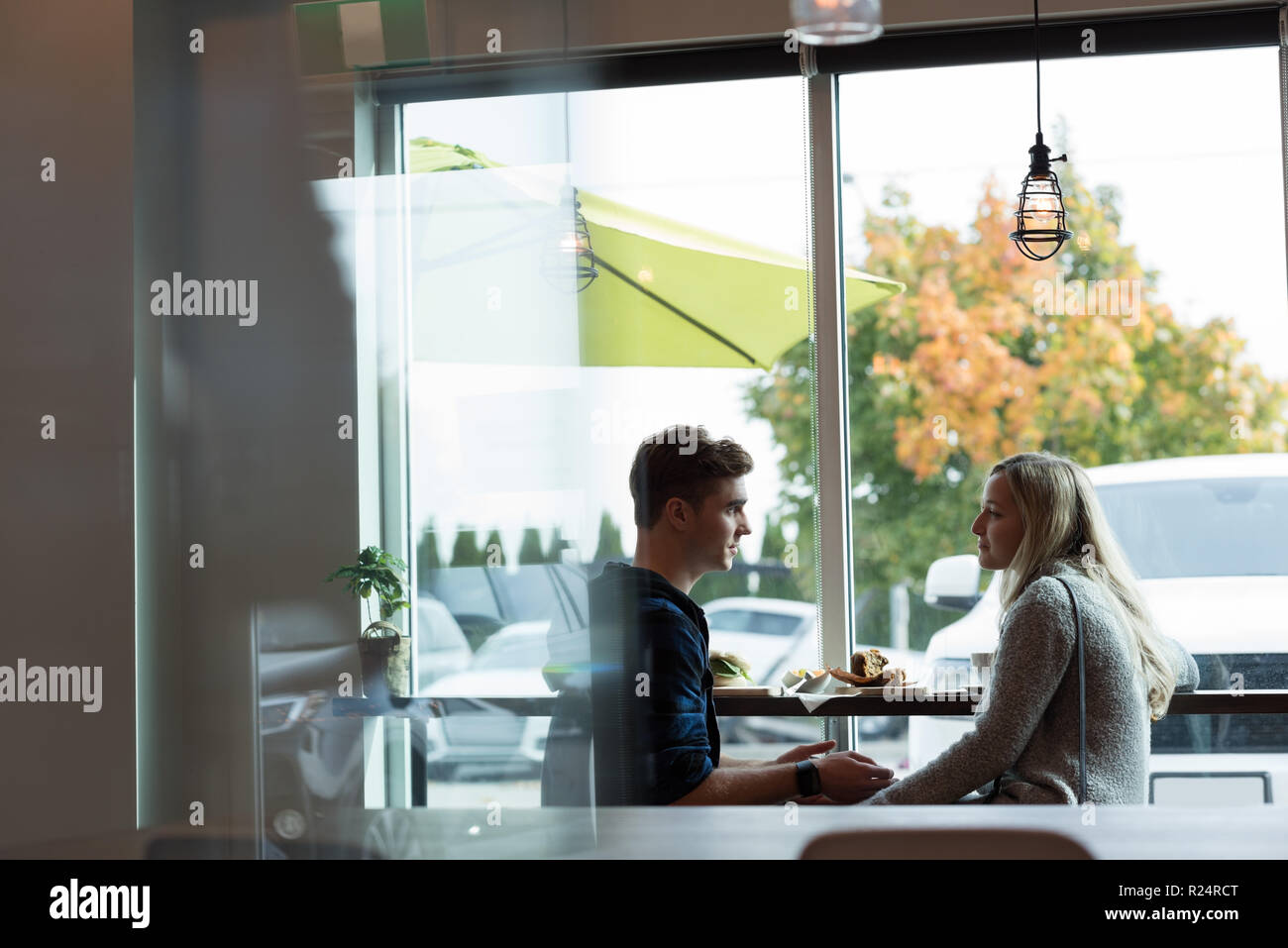 Couple interacting with each other in cafe Stock Photo