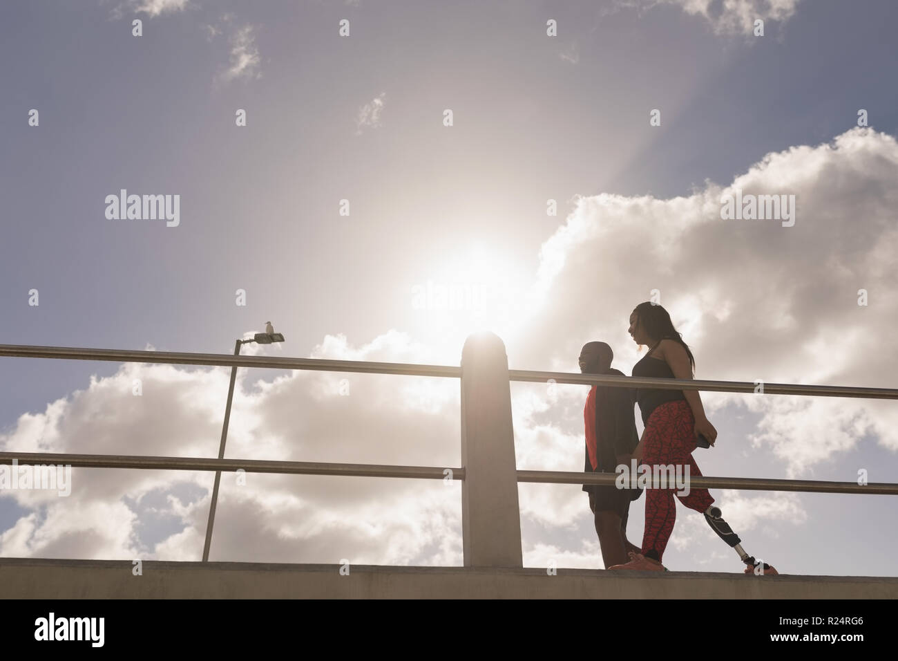 Couple holding hands and walking on promenade Stock Photo - Alamy