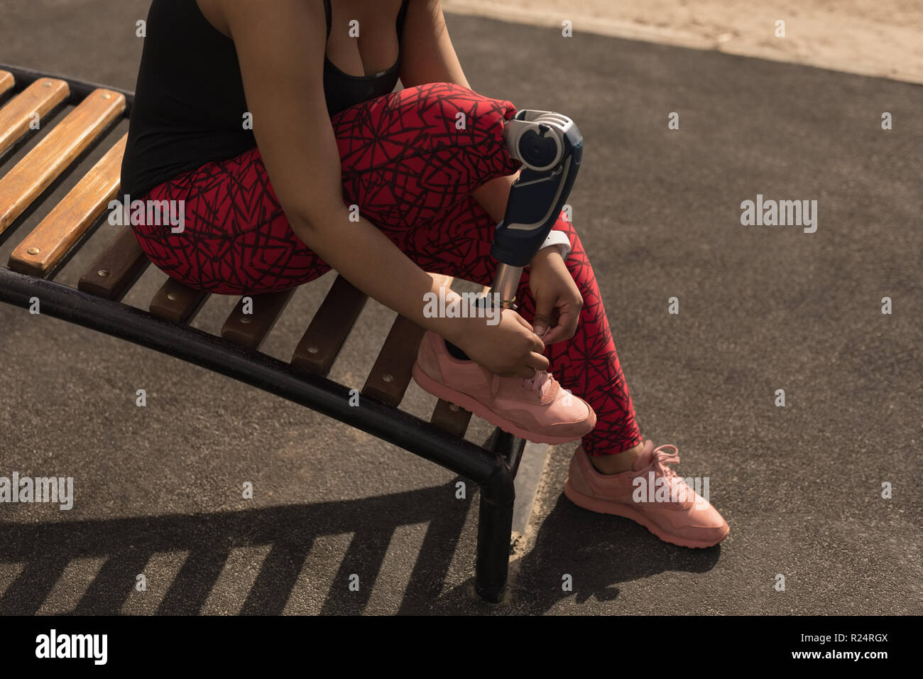 View of Disabled woman tying shoelace Stock Photo - Alamy