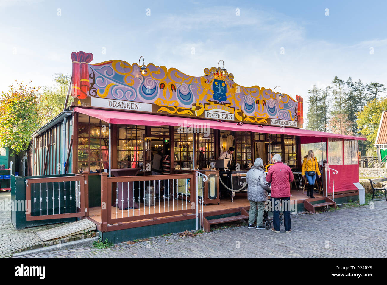 Arnhem,Netherlands- November, 04, 2018: Eldery couple wating to be served in front of an old Poffertjes stall Stock Photo