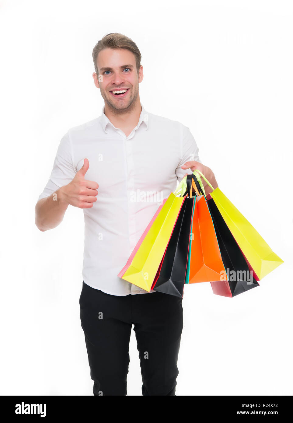Black friday sale concept. Man formal clothes carry shopping bags. Guy happy carry bunch shopping bags. Profitable deals on black friday. Man hold lot paper bags packages after shopping in mall. Stock Photo
