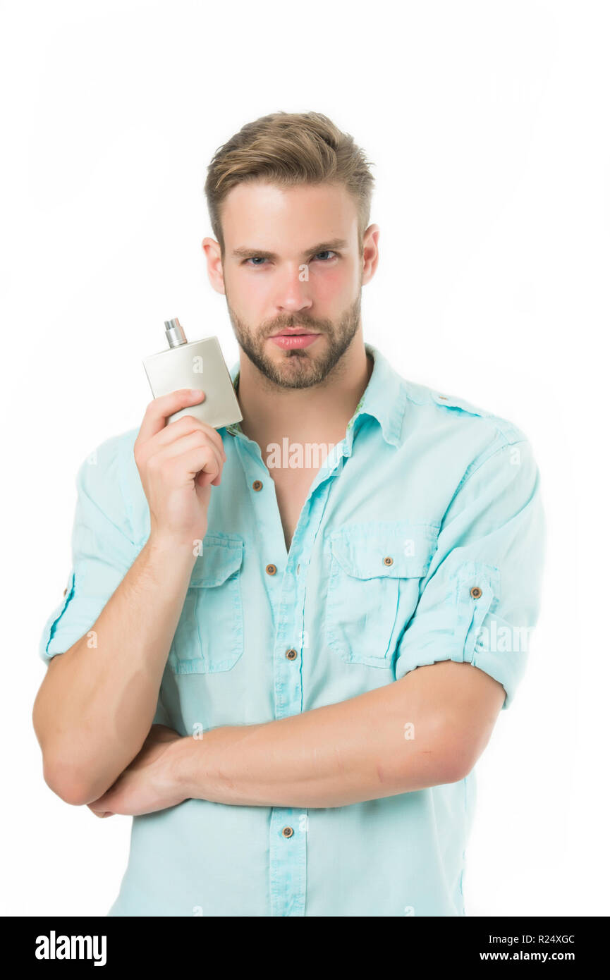 Man confident face hold perfume bottle. He likes this fragrance. Male