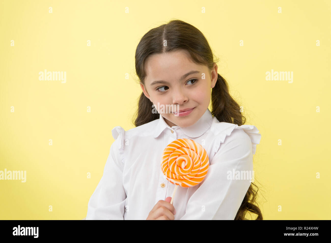 Girl happy face holds sweet lollipop ok gesture. She deserved candy
