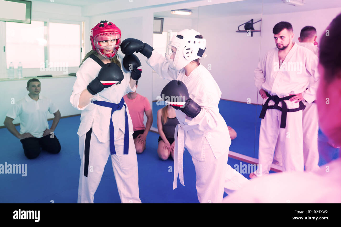 Young girls demonstrate their martial arts skills in teaching taekwondo