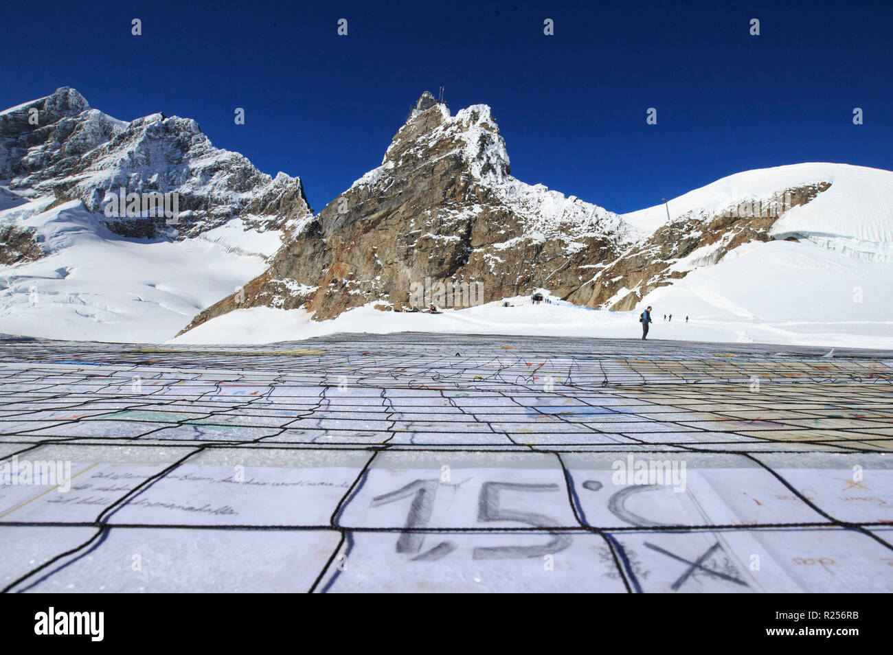 (181116) -- JUNGFRAUJOCH (SWITZERLAND), Nov. 16, 2018 (Xinhua) -- A gigantic postcard with the writing of 1.5 degrees Celsius is seen on the Aletsch glacier under Jungfraujoch in Switzerland, on Nov. 16, 2018. The gigantic postcard breaking the Guinness World Records was staged just under the Swiss Jungfraujoch on Friday to raise awareness worldwide of the emergency and necessity to fight climate change. At the center of the postcard was a huge slogan reading 'STOP GLOBAL WARMING #1.5 ¡ãC' to signify the goal of limiting global warming to a maximum of 1.5 degrees Celsius, a target recently set Stock Photo