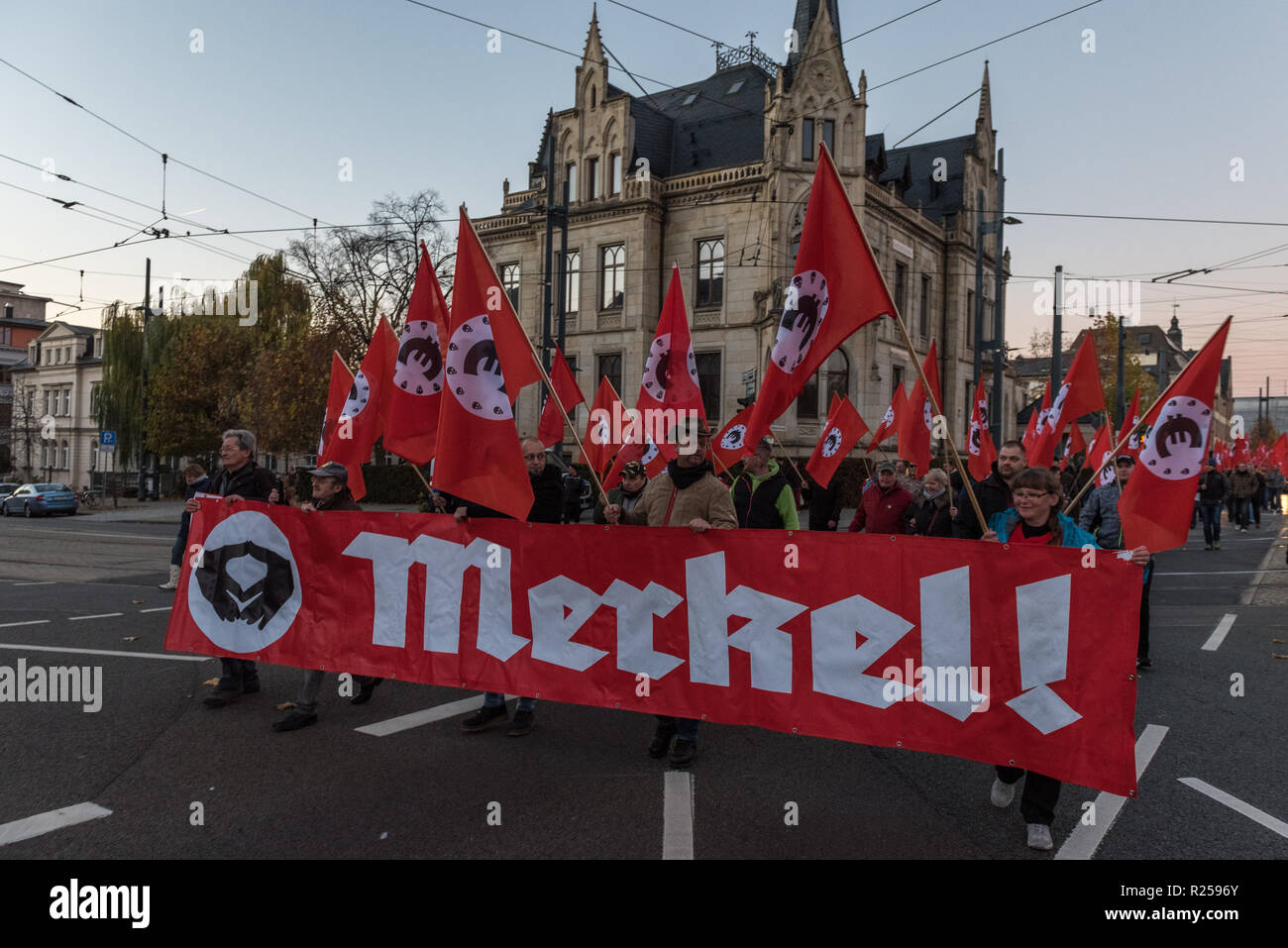 Counter protesters seen holding a Merkel banner during the right wing protest. Right-wing protests against Merkel's visit to Chemnitz, Deutschland. The Chancellor visited the city and talked to the citizens in a citizens' forum after protests and riots broke out in August after a violent death of a 35-year-old man from Chemnitz. Stock Photo